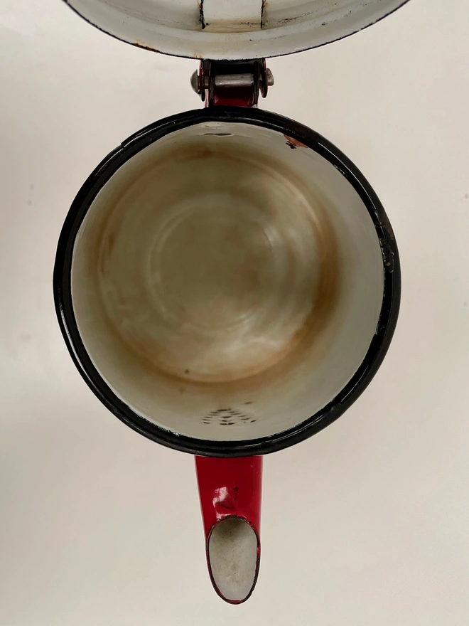 Inside of red coffee pot. The inside is slightly tea stained but in good condition. 