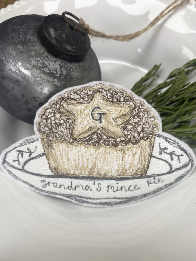 Embroidered Mince Pie Fabric Decoration on a plate with a bauble