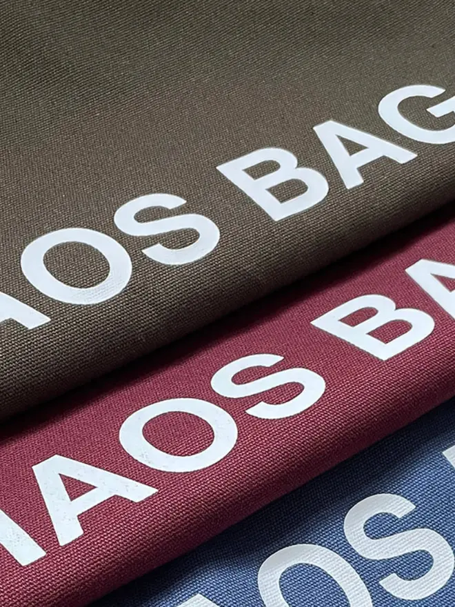 'Chaos' Tote Bag, three bags staked on each other. 