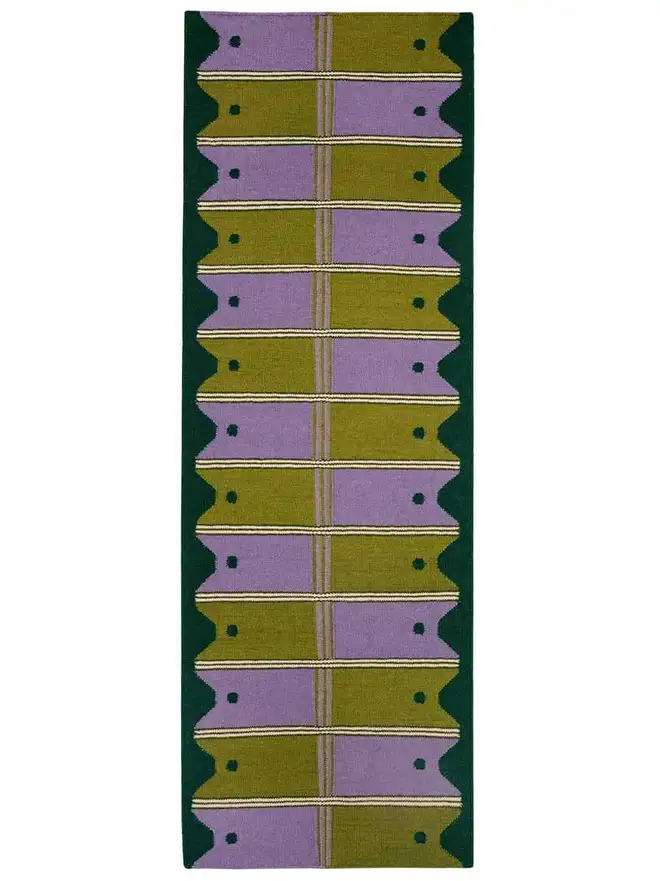Ladder Flatweave Runner Rug, a colourful rug sitting on a white surface. 