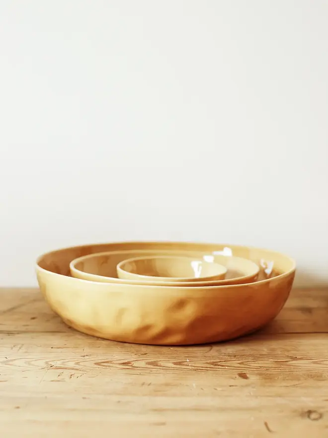 'dijon' handcrafted stoneware serving bowls. a set of three yellow serving bowls.