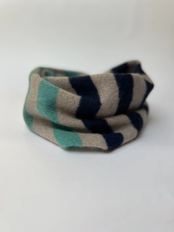 Knitted snood in jade mushroom and navy stripes shown on a white background