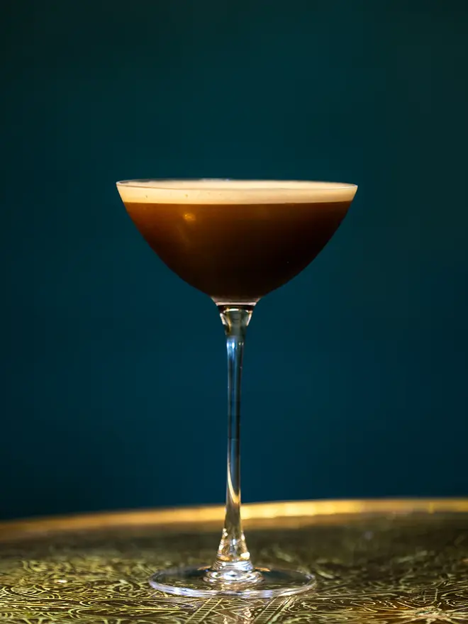 Coconut Espresso Martini, glass of espresso martini on a table. 