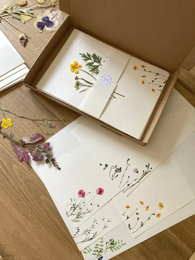 Pressed Wildflower Letter Writing Set, a pressed flower writing set sitting on a wooden surface. 