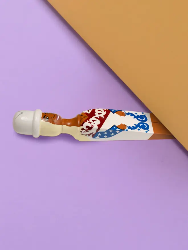 Wooden Door Stopper (Queen B Stars Outfit), a colourful wooden door stop sitting under a door.