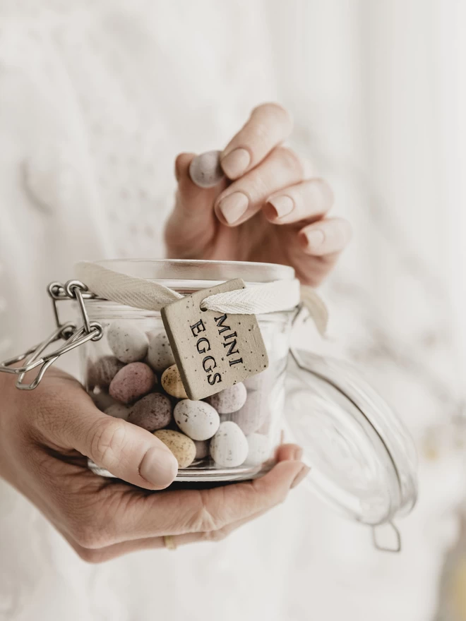 jar of mini eggs with a ceramic 'mini eggs' tag tied around it