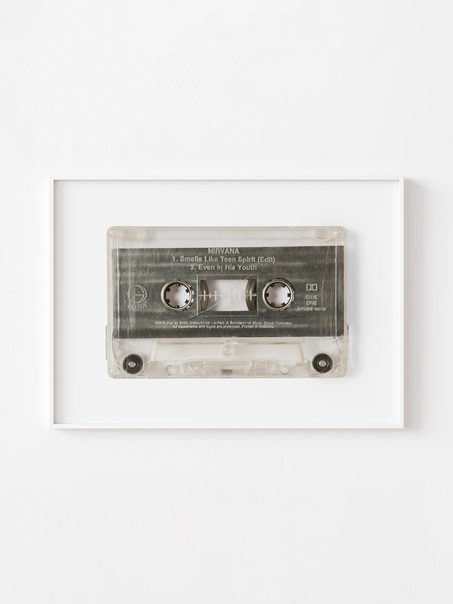  Nirvana 'Smells Like Teen Spirit cassette tape print. framed print hung up on white wall.
