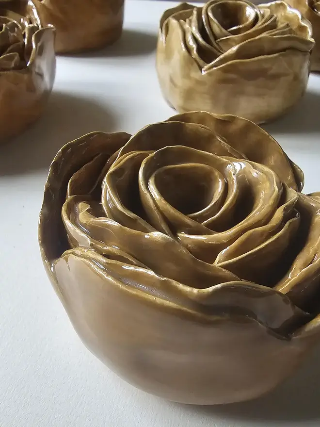 caramel tan camel brown handmade ceramic rose sculpture with a glossy glaze, crafted in 3D and designed to hang on a wall