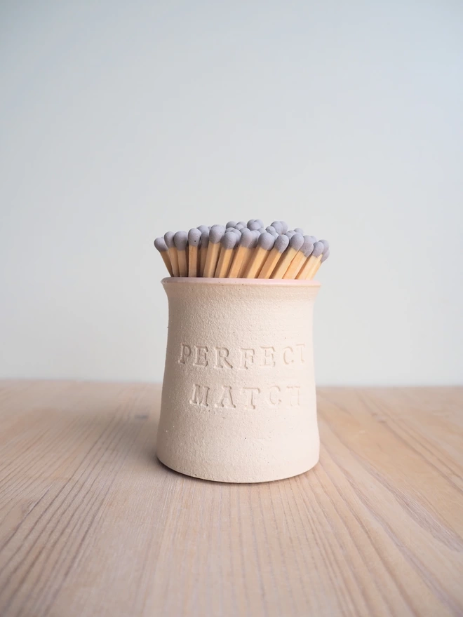 'perfect match' match pot with pale pink glaze inside. Grey tip matches in the pot