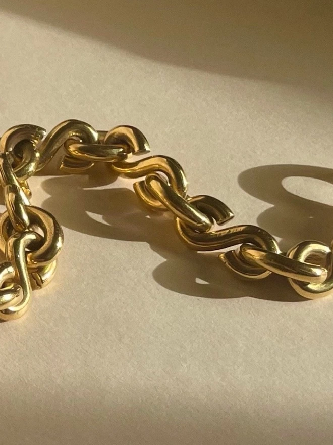 Close up of a bold gold chain bracelet