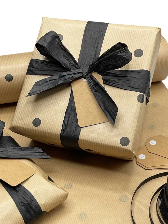product gift wrapped with brown spotty paper and black ribbon