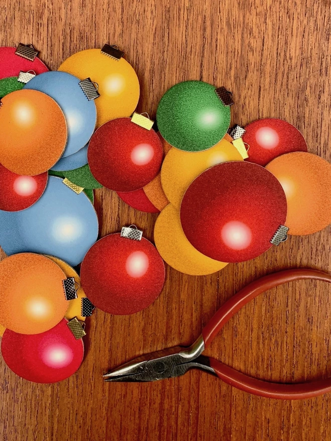 A set of brightly coloured, handmade paper and cork baubles