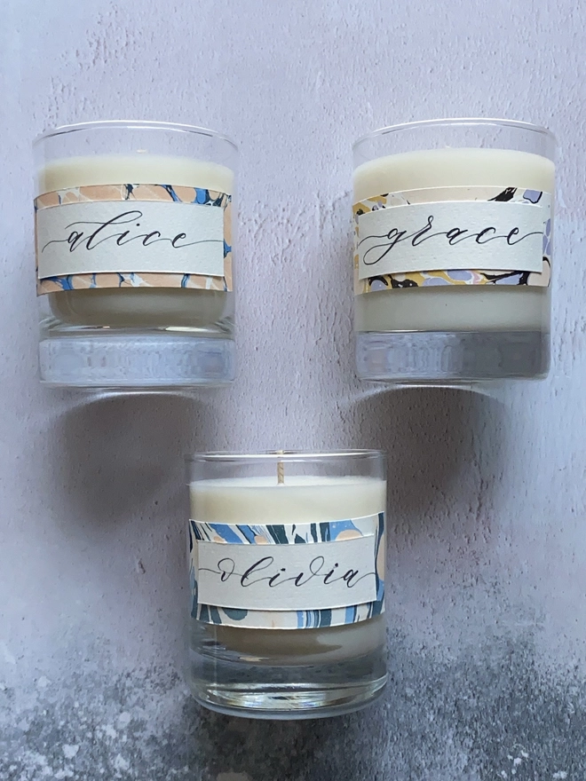Hand Poured Scented Candle With Personalised Marbled Label seen as a set of three.
