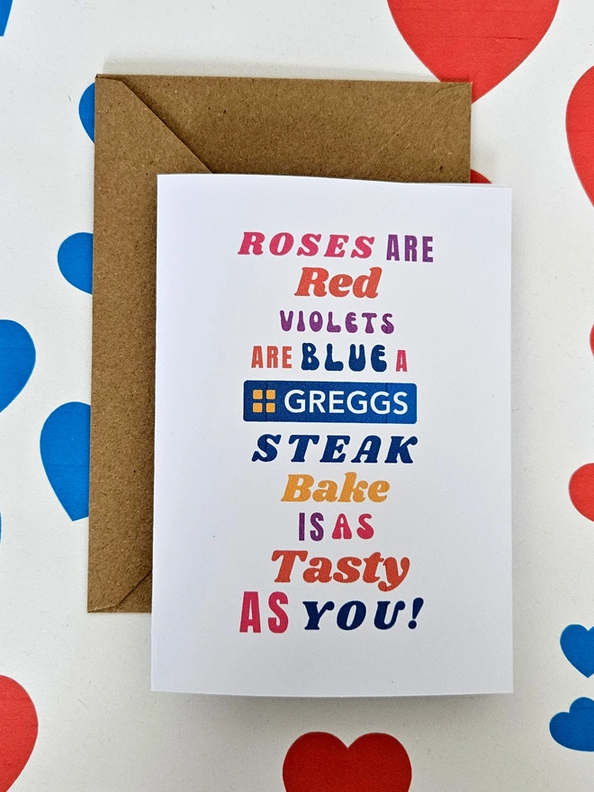 A humorous valentine greeting card that says rose are red violets are blue a Greggs steak bake is a tasty as you in colourful text in different fonts