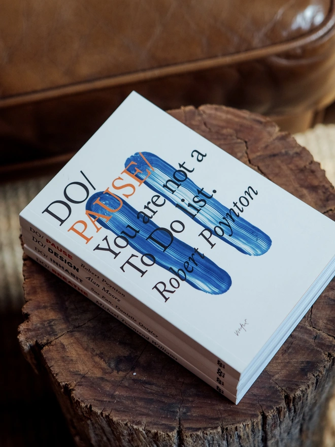 Book resting on wooden tree stump table by sofa