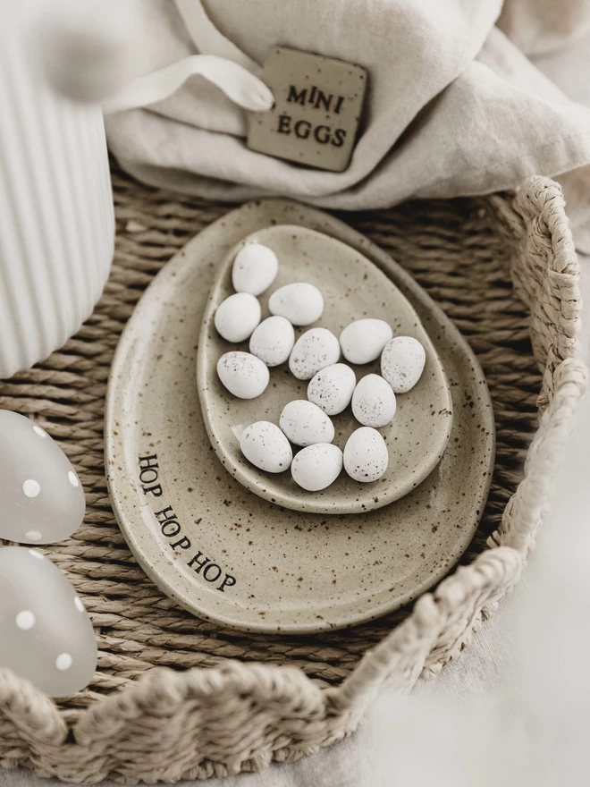 ceramic egg shaped plate with the words 'hop hop hop' around the edge