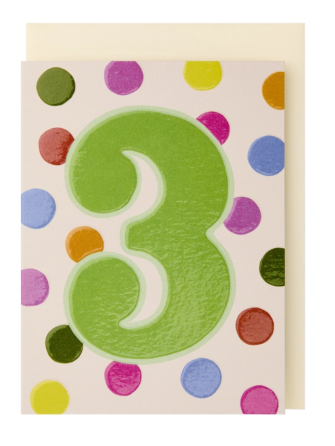 A colourful polka dot card with a large green 3 in the centre