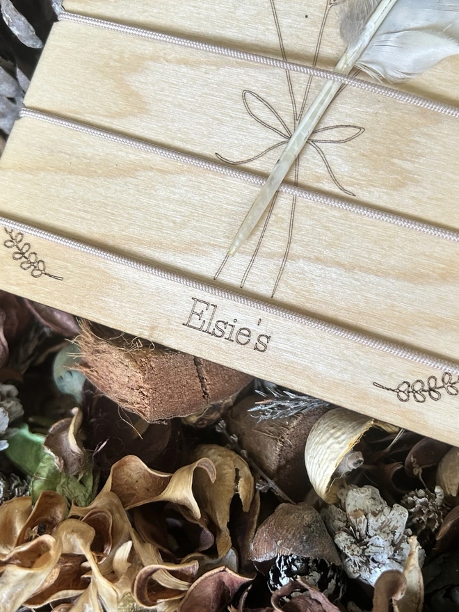 A Birch Wood Nature Trail Weaving Board showing a name personalised, on the forest floor