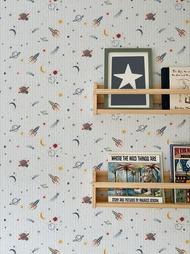 Ducks In A Row To Infinity Space themed kids wallpaper in boys bedroom with shelving