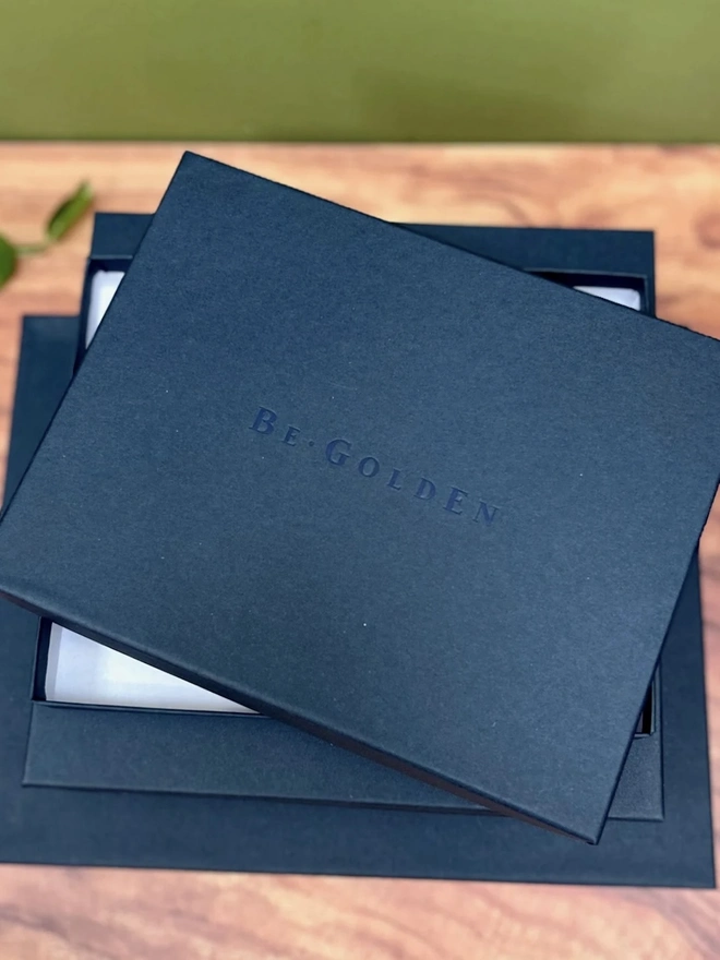 Personalised Landscape Guest Book With A Minimalist Font, guest book packaged on wooden table. 