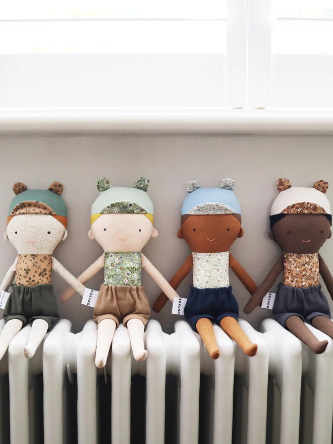 boy dolls with different outfits and skin tones 