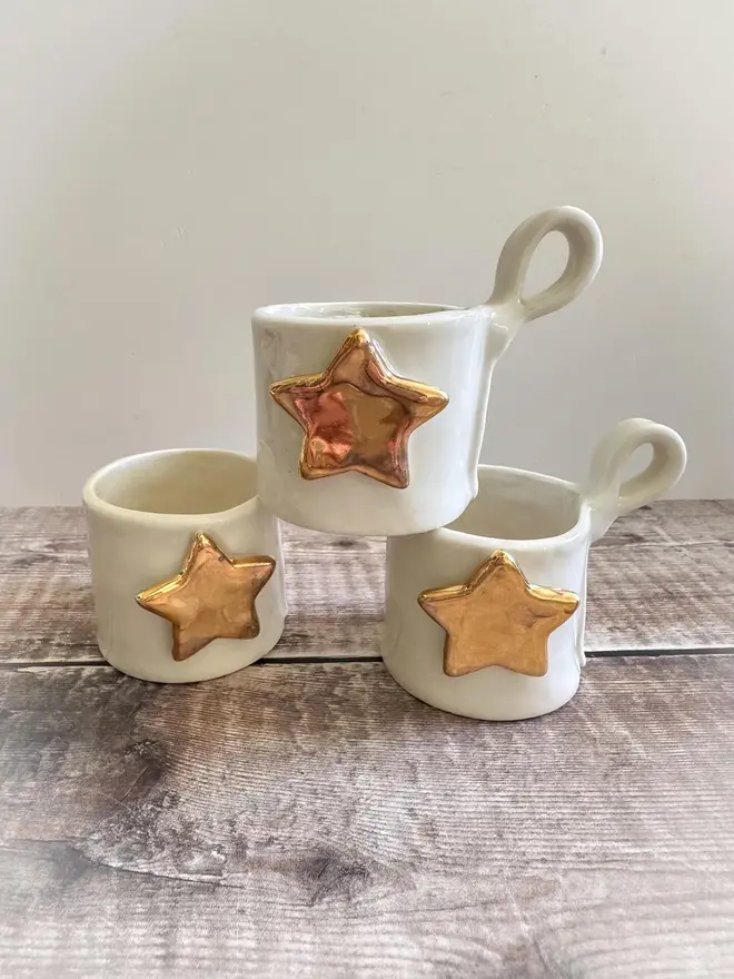 Porcelain Tea Light Holder Cup, set of three tea light holders stacked on a table. 