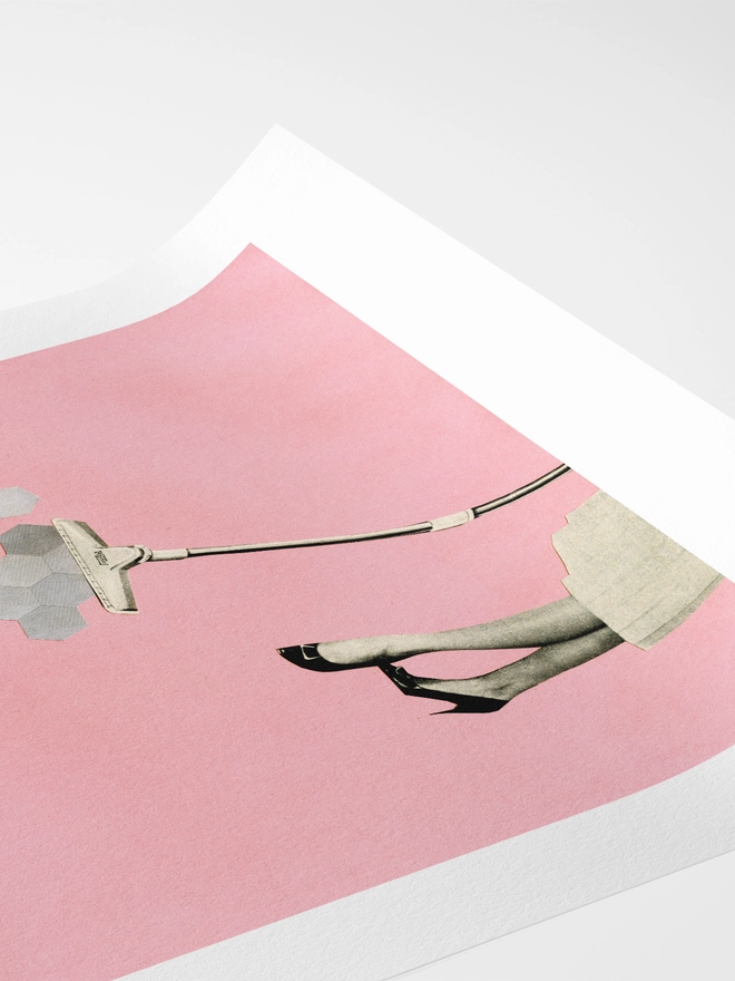 A retro print featuring a woman hoovering up geometric shapes.
