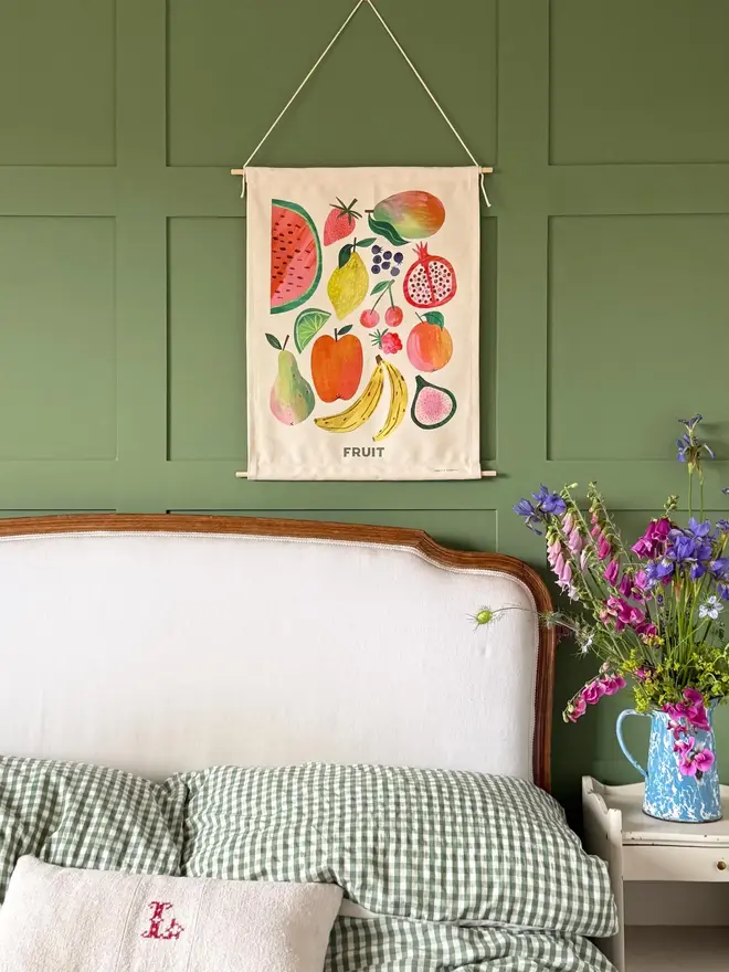 Fruit Print Fabric Banner, hanging on a green wall. 