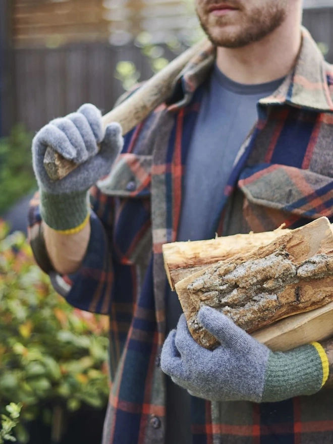 Block Lambswool Gloves, a pair of colourful gloves worn by a man having just chopped wood. 
