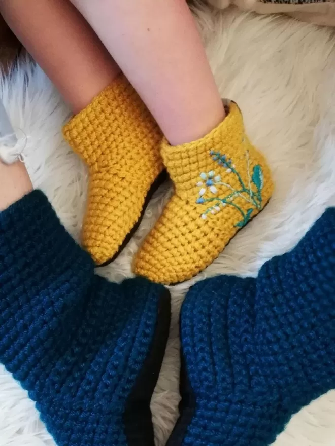 EKA crotched yellow and blue boots seen with embroidered flowers.