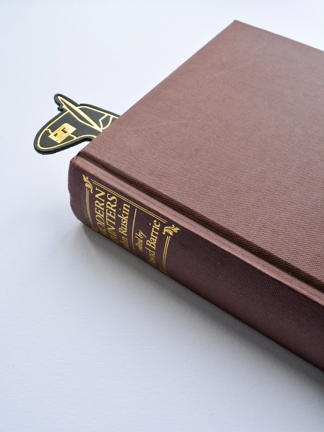 a closed book with a leather spitfire bookmark by natthakur