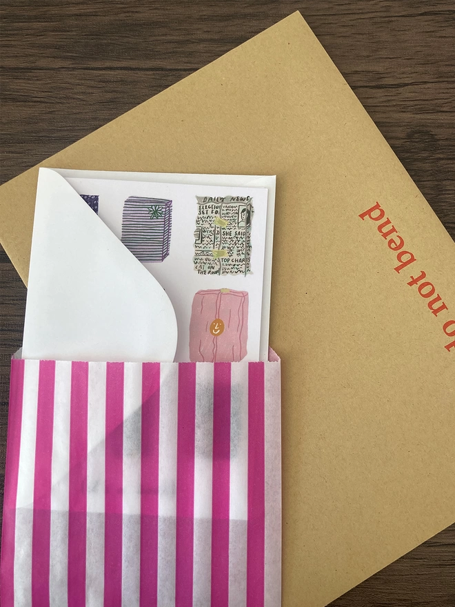 Greetings card packed with a white envelope inside a paper bag