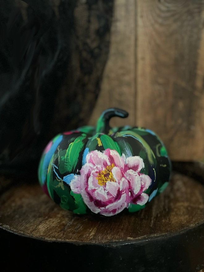 Unique hand-painted floral ceramic pumpkin black background vibrant bold pink peony flowers 