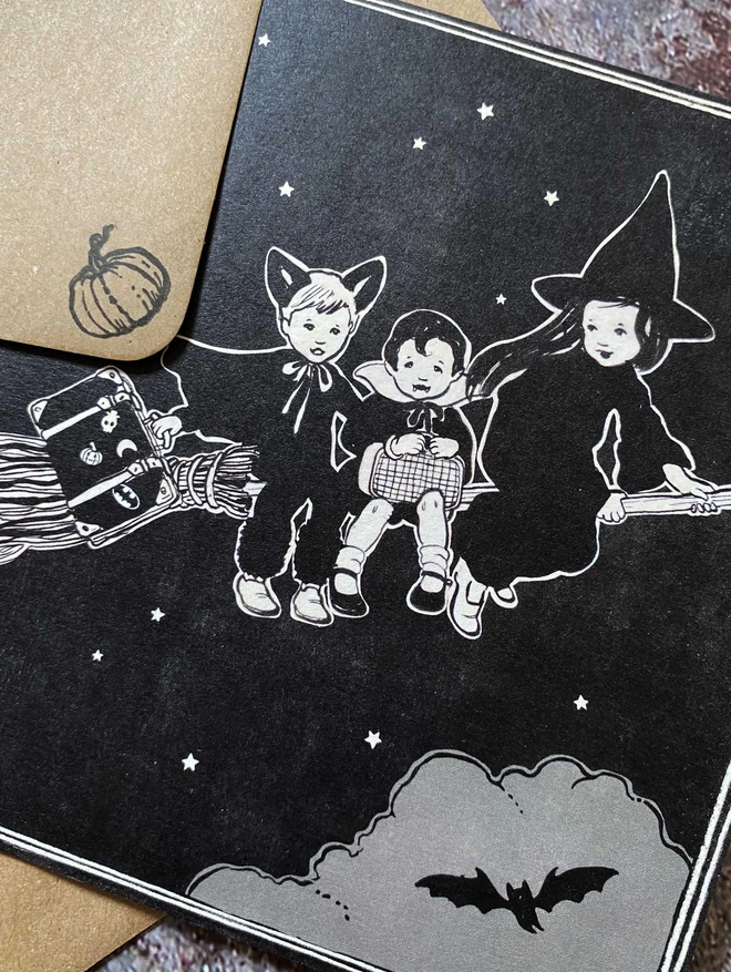 close up of a vintage style illustration of a witch and vampire boy and bat boy on a broom stick in the night sky