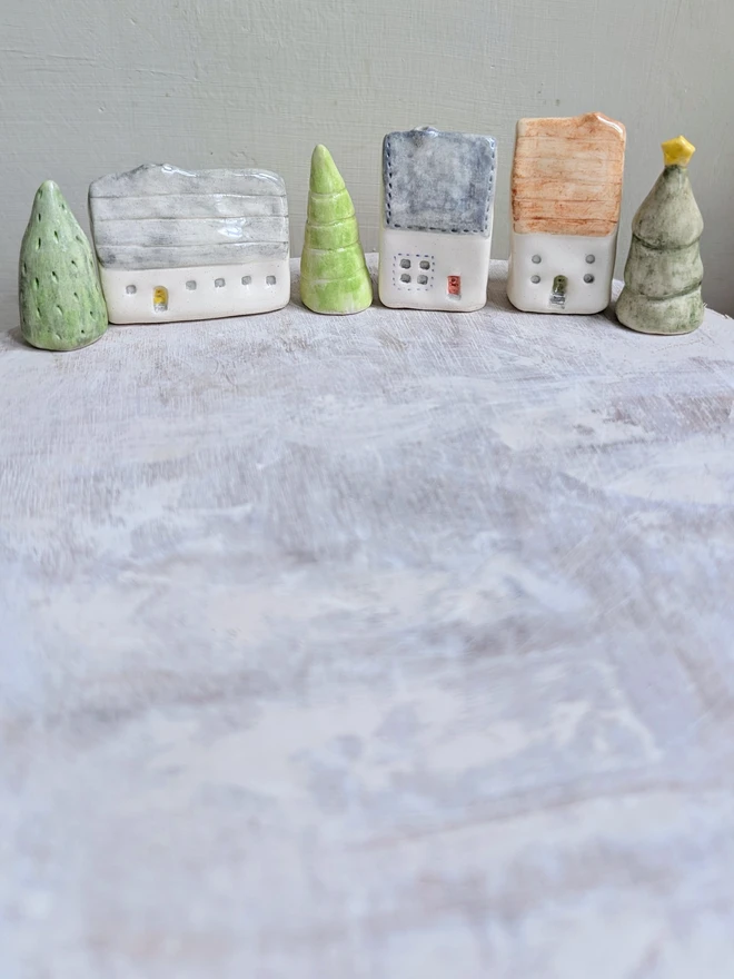 miniature ceramic houses and trees in a line for ornament or christmas cake topper decoraton 