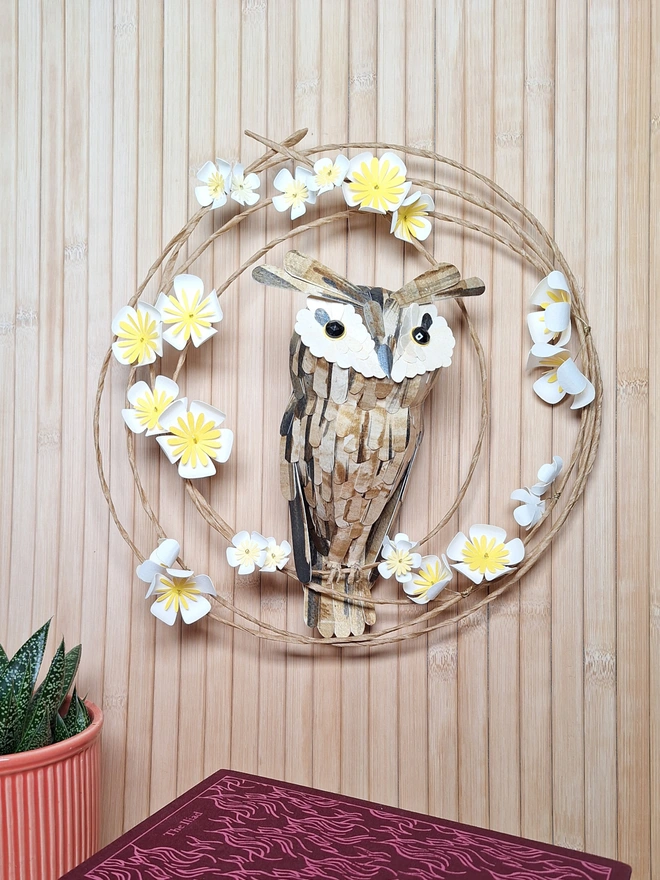 Handmade paper flower wreath featuring a long eared owl sculpture
