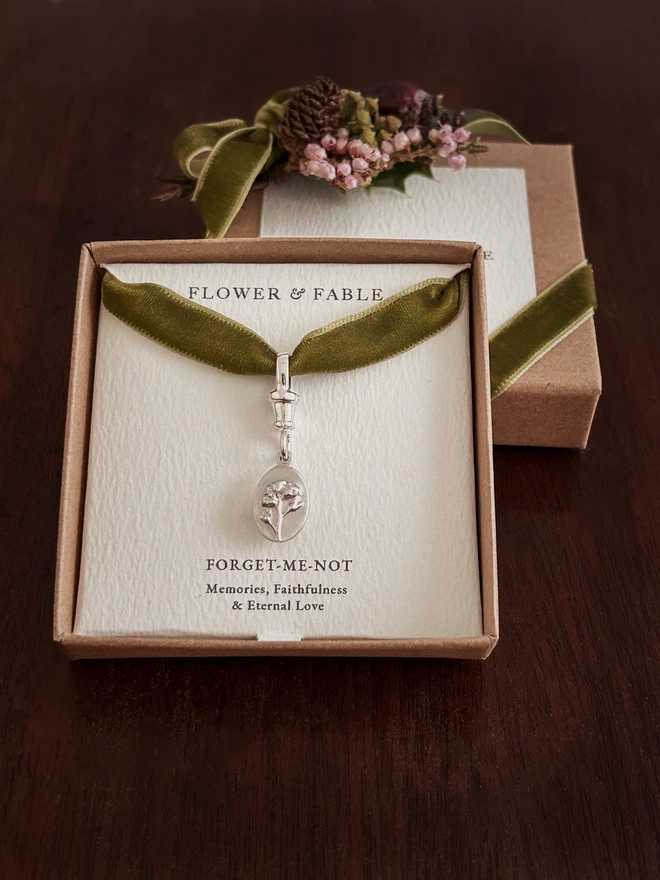 Forget me not medal charm with albert swivel clasp and green ribbon in a gift box