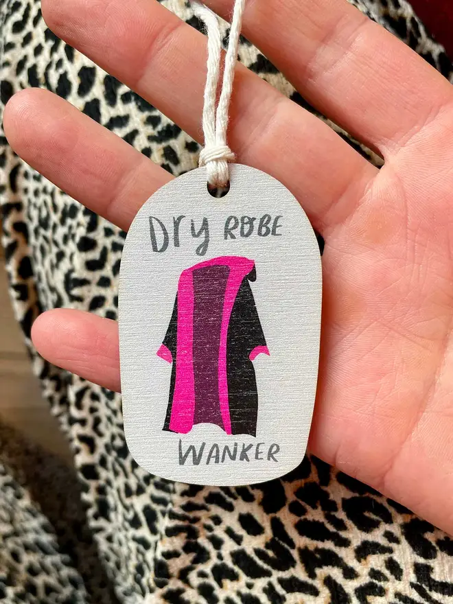 Wooden ornament reads 'dry robe wanker'