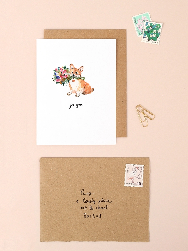 A delightful illustration of a cheerful corgi holding a vibrant bouquet of flowers in its mouth, conveying a message of affection and joy. The corgi's expressive eyes and the colorful blooms add a touch of warmth and playfulness. Beneath the scene, the handwritten message "for you" adds a personal and heartfelt touch. The design combines soft, earthy tones and charming details, making it a perfect choice for expressing love and appreciation.
