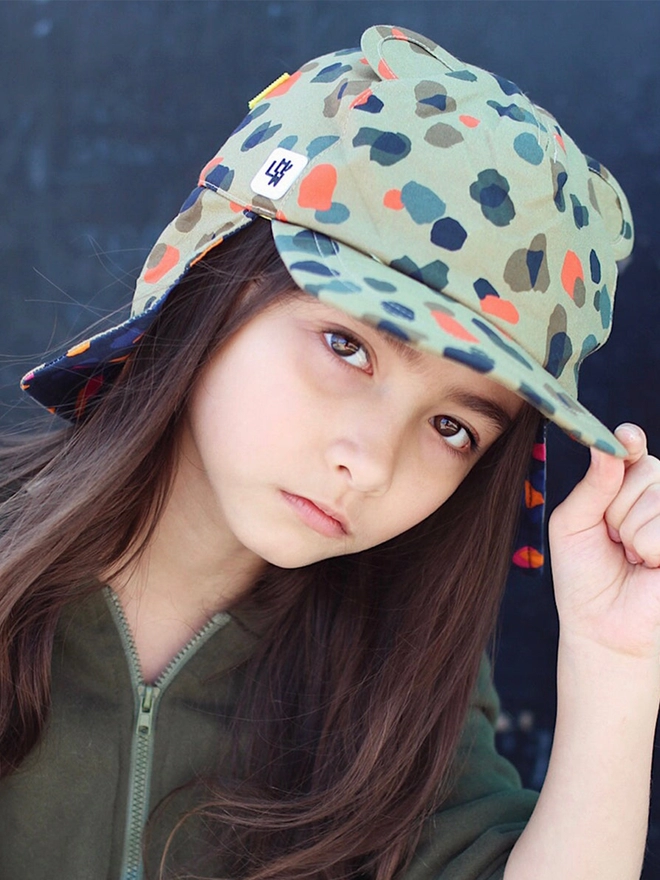 Girl wearing sun baseball hat in leopard neutral print