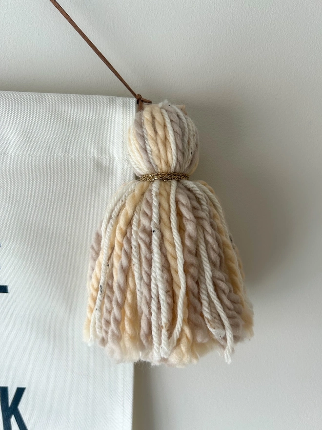 To the Moon and Back fabric printed banner with neutral caramel tassels and gold trim