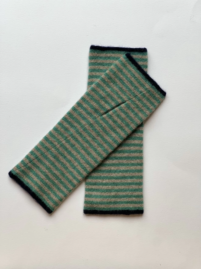 Knitted striped wristwarmers laid on top of each other