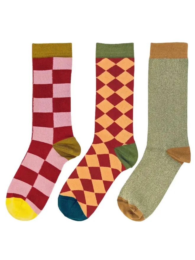Women's Organic Cotton Ankle Socks Packs (Sets Of 3), a pack of three colourful patterned socks sitting on a plain white surface. 
