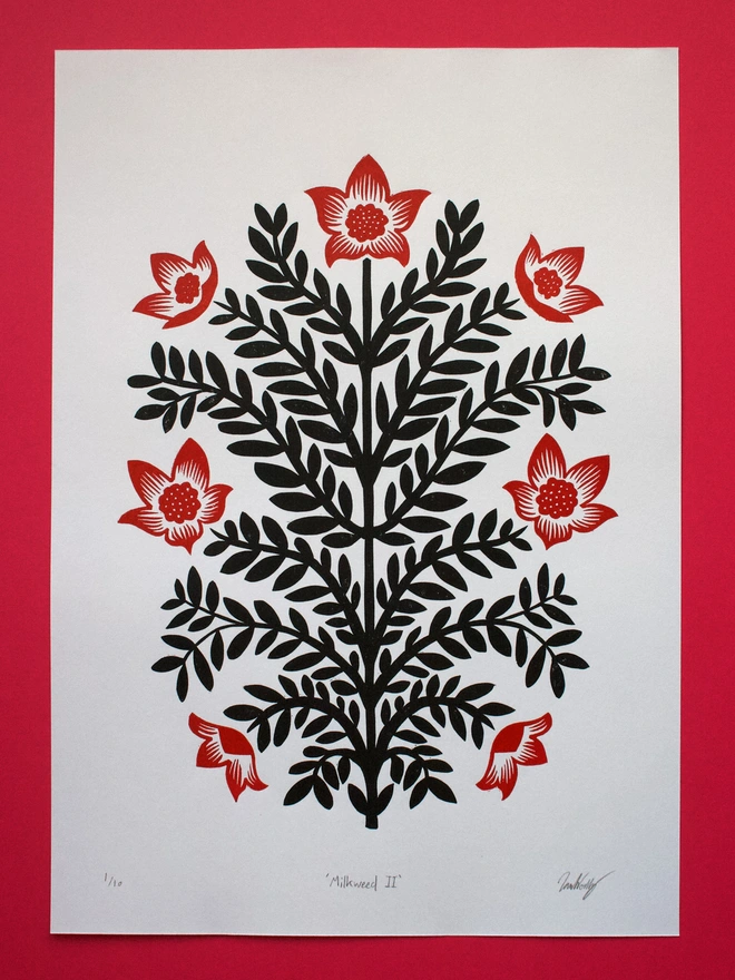 Handmade linocut print of milkweed flowers printed in red and black ink