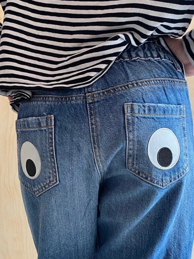 Googly eye iron on patches on jeans pockets