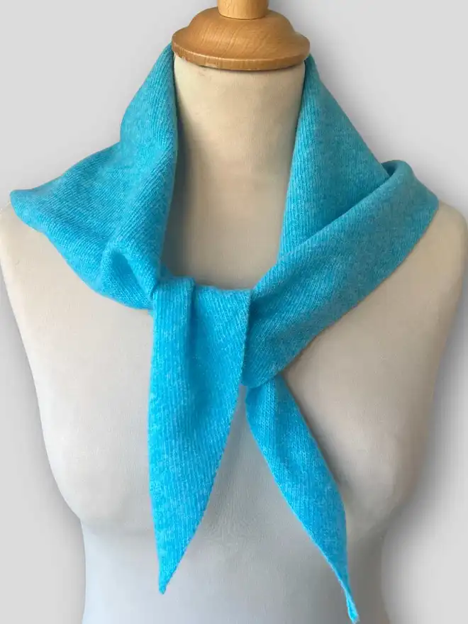 Turquoise triangle scarf shown from front on mannequin