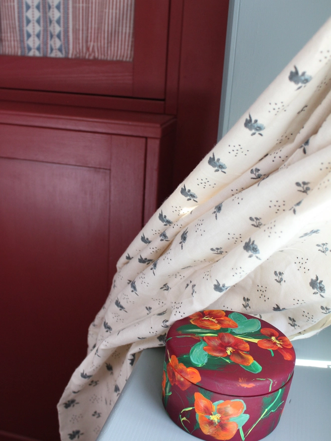 hand painted floral ceramic round box background painted in a deep maroon adorned in fiery Nasturtium flowers