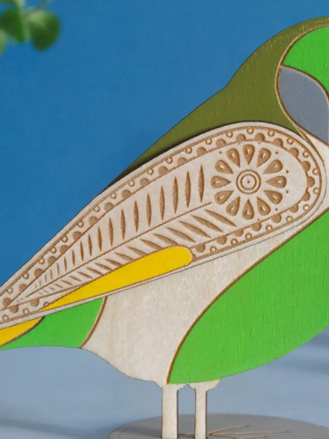 Standing Wooden Greenfinch, green wooden bird standing on a platform. 