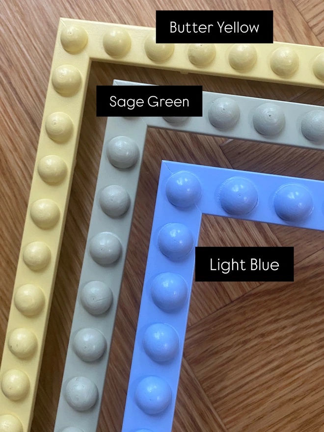 Colour swatches of bobbin mirrors in butter yellow, sage green and light blue