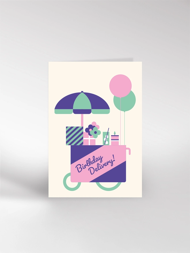 Birthday card featuring a delivery wagon loaded with presents, flowers, drinks, cake and balloons